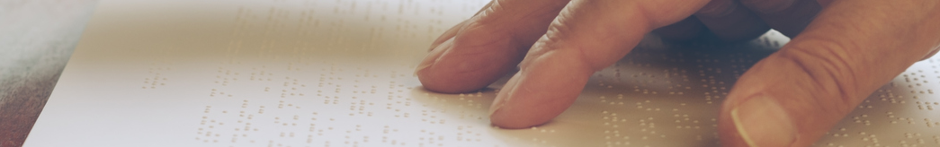 Hand running across a braille document